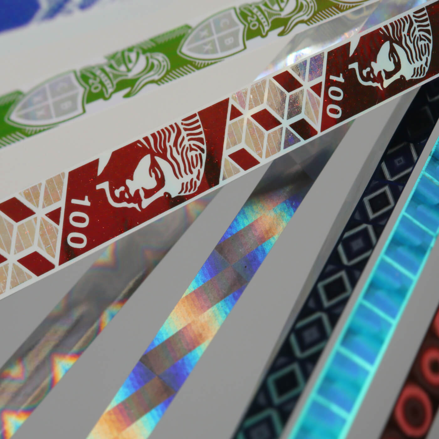 a collection of multi-coloured security thread ribbons to be applied to bank notes
